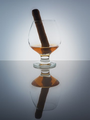 Glass whisky brandy cognac Cuban cigar background light gradient luster