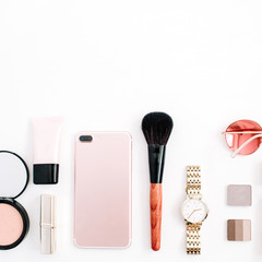 Beauty blog fashion concept. Female pink styled accessories: cell phone, watches, sunglasses, cosmetics on white background. Flat lay, top view trendy feminine background.