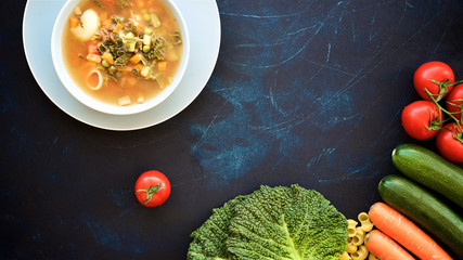 Bowl of soup Minestrone. Food background. Dark blue structural background. Italian Cuisine 
