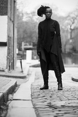 Black Woman in Long Coat Standing in the Street