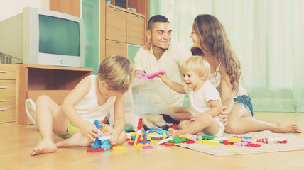 Obraz na płótnie Canvas Happy family playing in home interior
