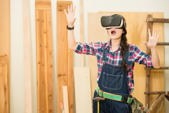 woman carpenter shocked  looking vr device