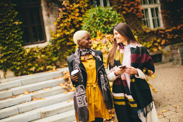 Young multiracial friends walking around the town