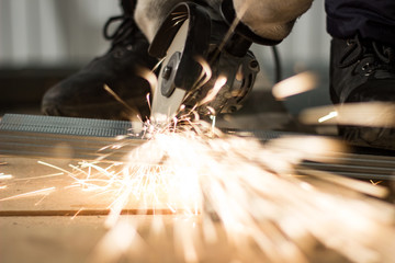 Master sawing metal, sparkles with bright sparks