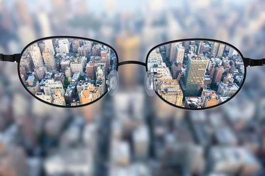 Clear cityscape focused in glasses lenses