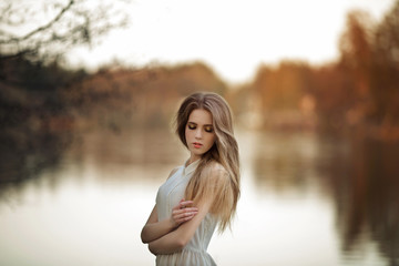 Portrait of tender girl with closed eyes outdoors