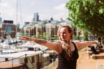 Woman in Yoga position at harbour