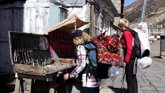 Female trekkers choosing souvenires