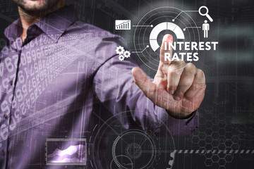 Business, Technology, Internet and network concept. Young businessman working on a virtual screen of the future and sees the inscription: Interest rates