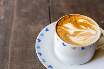 cup of coffee on wood table blackground