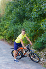 Naklejka premium A young guy on a bike outdoors