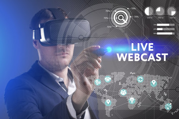 Business, Technology, Internet and network concept. Young businessman working in virtual reality glasses sees the inscription: Live webcast