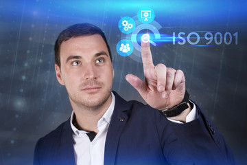 Business, Technology, Internet and network concept. Young businessman working on a virtual screen of the future and sees the inscription: ISO 9001