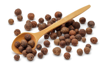 Allspice berries with wooden spoon