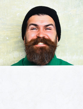 bearded man posing on studio wall background