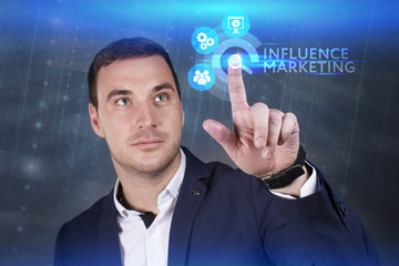 Business, Technology, Internet and network concept. Young businessman working on a virtual screen of the future and sees the inscription: Influence marketing