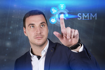 Business, Technology, Internet and network concept. Young businessman working on a virtual screen of the future and sees the inscription: SMM