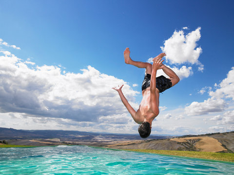 Man jumping in swimming pool