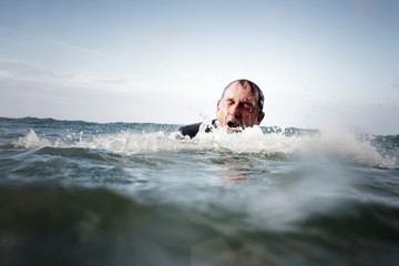 A businessman coming out of the sea