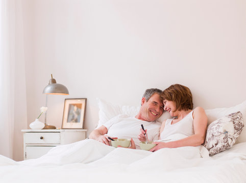 Eldery Couple Eating In Bed