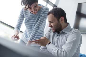 Two Business People Working With Tablet in startup office