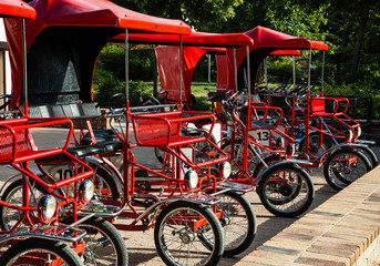 Fototapeta na wymiar Red retro quad bikes in Parc floral (public park and botanical garden) in Paris (France)