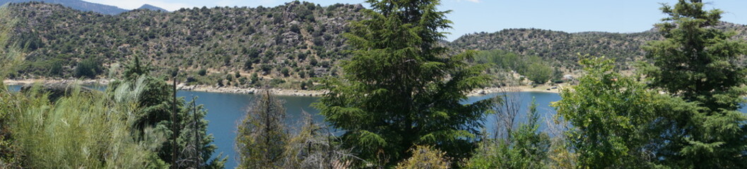 The El Burguillo Reservoir panoramic view. It is located along the Alberche river in the province of Ávila, Spain, between the municipalities of El Tiemblo and El Barraco.