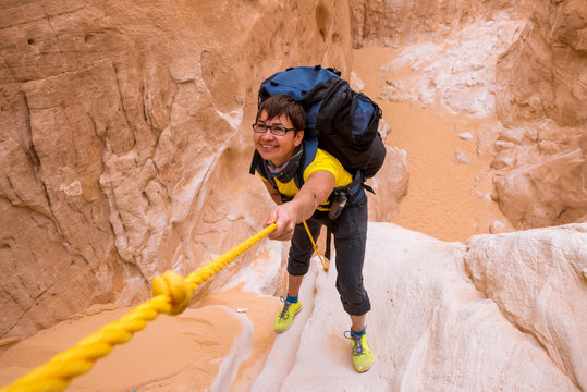 Woman climbing in canyon, Sinai, Egypt