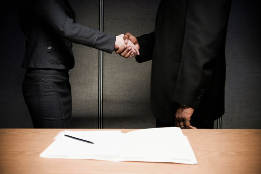 Man and woman in suits shaking hands