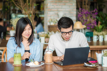 Two young business having a successful co-working at vintage restaurant.