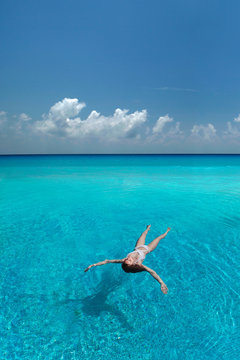Woman floating in tropical sea