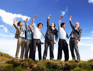 Businessmen cheering outdoors