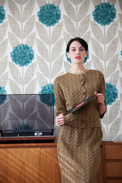 Woman in vintage dress with vinyl record