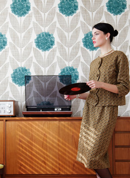 Woman in vintage dress with vinyl record