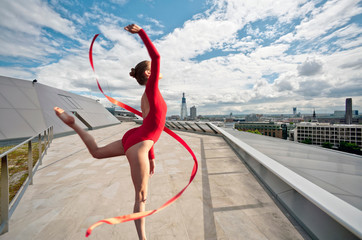 Dancer with ribbon on urban rooftop