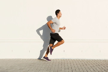 middle age man running by white wall