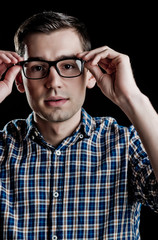 young guy, nerd in glasses and fashionable checkered shirt