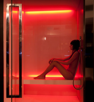 Nude woman relaxing in sauna in spa