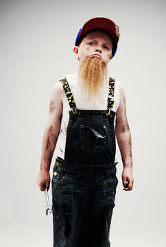 Young boy dressed up as mechanic with beard