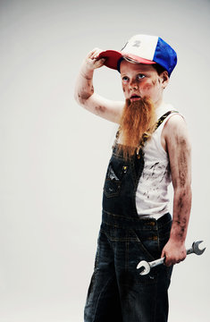 Young boy dressed up as mechanic with beard