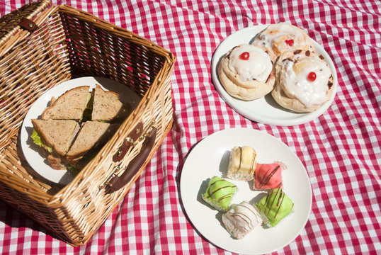Picnic hamper with sandwiches and cakes
