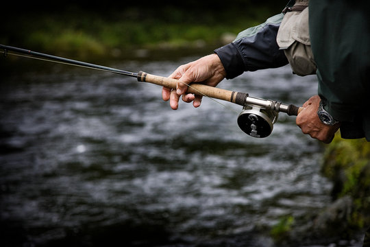 Casting fishing rod in Margaree River, Cape Breton Island, Nova Scotia