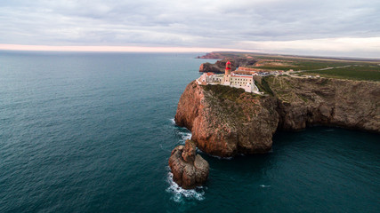 Aerial View lighthouse and cliffs at Cape St. Vincent at sunset. Europe's most South-western point,...