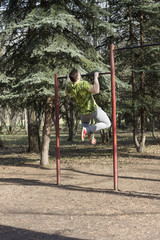 A young guy goes in for sports in summer Park