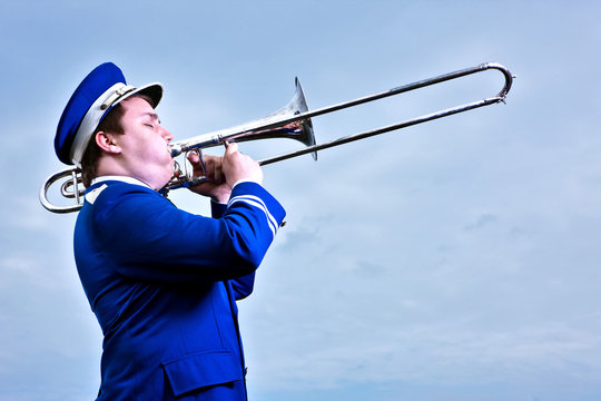 Portrait of young man playing trombone