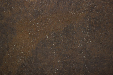 An abstract picture of a variety of shapes and dots on an old rusty metal sheet