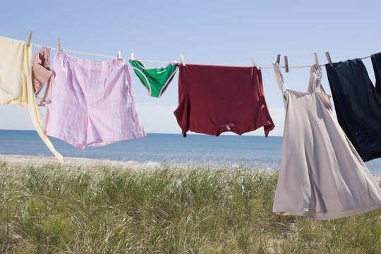 Laundry drying on clothes line by sea