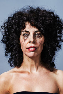Woman crying with makeup smudged on face