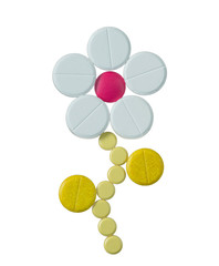 Daisy Flower made of different colorful pills isolated on white background