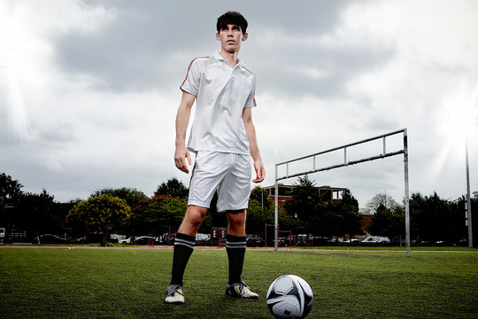 Soccer player standing on pitch